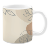 White 11oz ceramic mug featuring a minimalist design with soft beige and tan tones. The artwork includes delicate line drawings of leaves and subtle overlapping shapes, creating a calming and modern aesthetic.