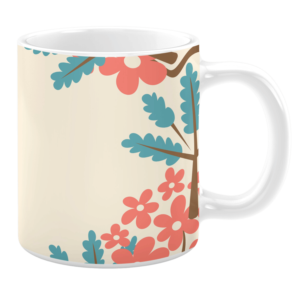 White 11oz ceramic mug featuring a cheerful design with coral pink flowers and teal leaves set against a light cream background. The pattern is framed by a tree branch, creating a playful and vibrant look.