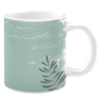 White ceramic 11oz mug featuring a textured, rustic design with a soft sage green background, subtle white distressed patterns, and a single fern leaf in deep green, evoking a calm and natural aesthetic.