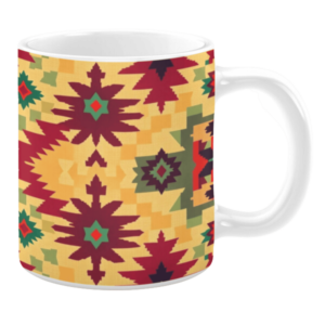 White ceramic 11oz mug featuring a bold geometric design with starburst and diamond motifs in red, green, and burgundy on a warm yellow background.