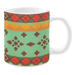 White ceramic mug featuring a vibrant, geometric pattern with rich colors such as red, orange, yellow, and brown against a soft green background, creating a bold and Southwestern-inspired design.