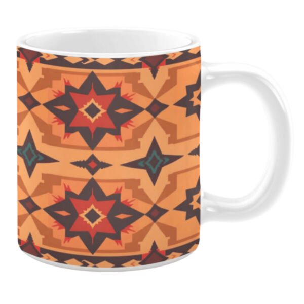 White ceramic mug featuring a Southwestern-inspired geometric design with bold red, orange, brown, and teal shapes, creating a striking and vibrant pattern reminiscent of desert and tribal aesthetics.