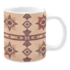 Ceramic mug with a soft beige background featuring geometric star motifs and diamond shapes in earthy tones of red, brown, and tan.