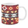 Ceramic mug featuring a bold geometric design with diamond and star motifs in red, yellow, and earthy tones, accented by white and teal stripes.