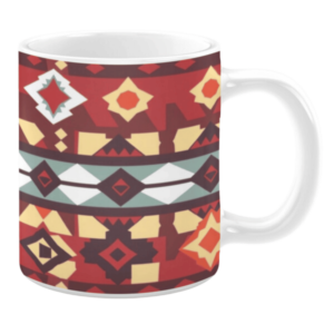 Ceramic mug featuring a bold geometric design with diamond and star motifs in red, yellow, and earthy tones, accented by white and teal stripes.