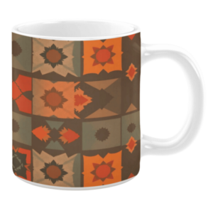 Ceramic mug featuring a patchwork-style design with geometric star and sun motifs in warm shades of orange, brown, and tan.