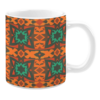 Ceramic mug featuring a geometric pattern with bold starburst designs in orange, green, and red tones on a dark brown background.