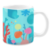 Ceramic mug featuring a vibrant underwater scene with illustrations of coral, abstract aquatic shapes, and sea plants in bold shades of red, pink, orange, yellow, and blue. The background includes subtle geometric patterns and bubbles, adding depth to the oceanic design.