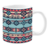 Ceramic mug featuring a horizontal pattern of geometric motifs in shades of blue, navy, red, and beige, with repeating diamond and triangle shapes.