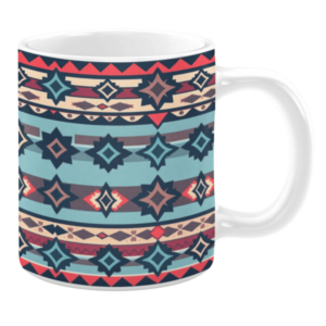 Ceramic mug featuring a horizontal pattern of geometric motifs in shades of blue, navy, red, and beige, with repeating diamond and triangle shapes.