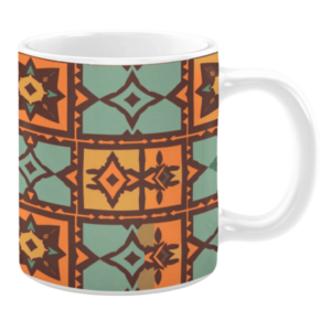 Ceramic mug featuring a tiled geometric pattern in orange, teal, and brown, with diamond and arrowhead shapes arranged in a grid layout.