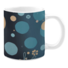 Ceramic mug with a minimalist design featuring scattered circles in muted tones of teal, blue, and beige. The dark background enhances the contrast, while subtle floral details and delicate line accents add a touch of organic elegance to the composition.