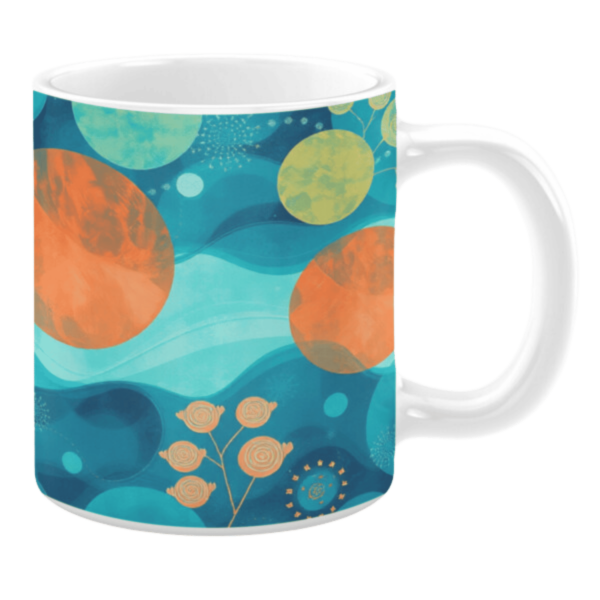 Ceramic mug with a cosmic-inspired design in aqua, teal, and orange hues. Features abstract circular elements resembling planets and stars, layered over wave-like patterns. Accents include subtle floral motifs and delicate dotted embellishments, creating a blend of celestial and organic themes.