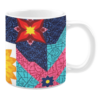 White ceramic mug featuring a bold patchwork design with vibrant floral and geometric patterns in bright shades of red, blue, pink, yellow, and turquoise, creating a dynamic and colorful aesthetic.