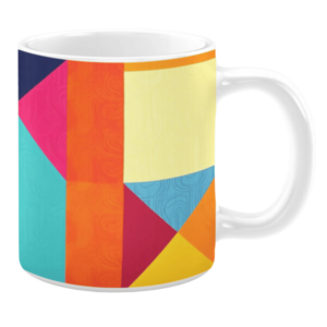Colorful ceramic mug with geometric patterns in orange, yellow, pink, and blue tones