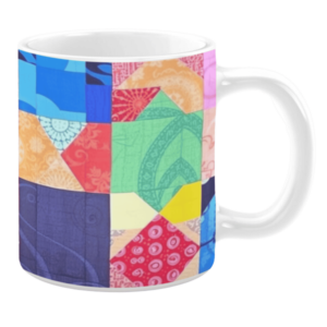 Colorful ceramic mug with geometric patchwork patterns in blue, green, red, and yellow tones
