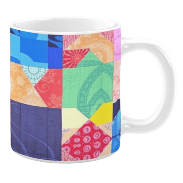 Colorful ceramic mug with geometric patchwork patterns in blue, green, red, and yellow tones