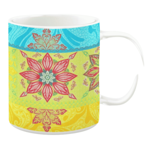 Colorful ceramic mug with floral and paisley patterns in yellow, green, and blue tones