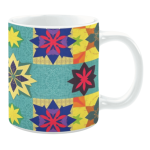 Colorful ceramic mug with geometric star patterns in blue, yellow, red, and green tones