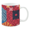 Colorful ceramic mug with red, blue, and orange floral and geometric patterns