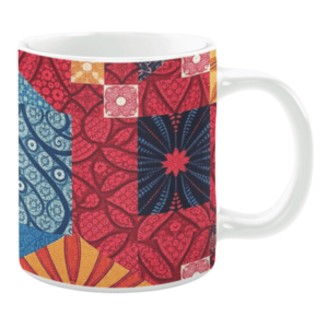 Colorful ceramic mug with red, blue, and orange floral and geometric patterns