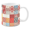 Colorful ceramic mug with patchwork patterns in red, beige, and blue tones