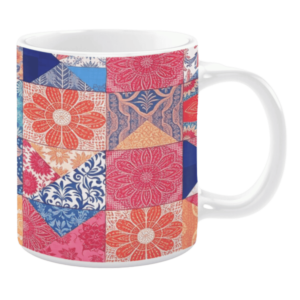 Colorful ceramic mug with floral patchwork patterns in red, blue, and pink tones