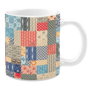Colorful ceramic mug with patchwork patterns in red, blue, beige, and green tones