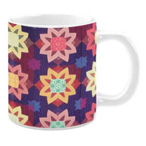 Colorful ceramic mug with star-shaped quilt patterns in purple, pink, yellow, and green tones