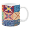 Colorful ceramic mug with quilt-inspired star and floral patterns